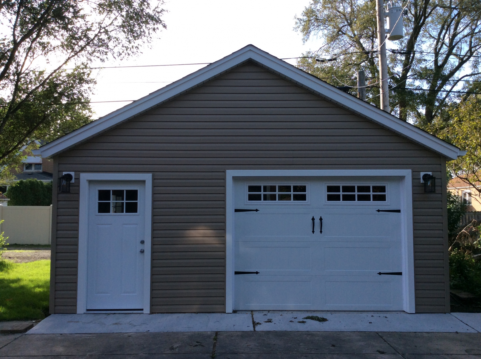 A spacious garage with two distinct doors, including a prominent white door, ideal for residential or commercial use.