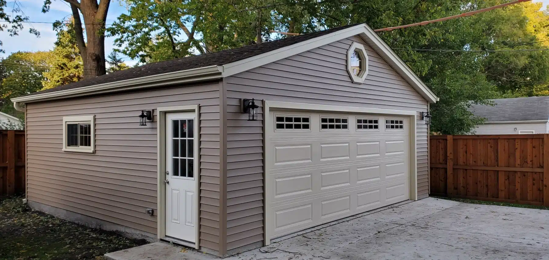 20211027_171432_resized A small garage featuring brown siding, showcasing a gable style design, ideal for residential construction projects.