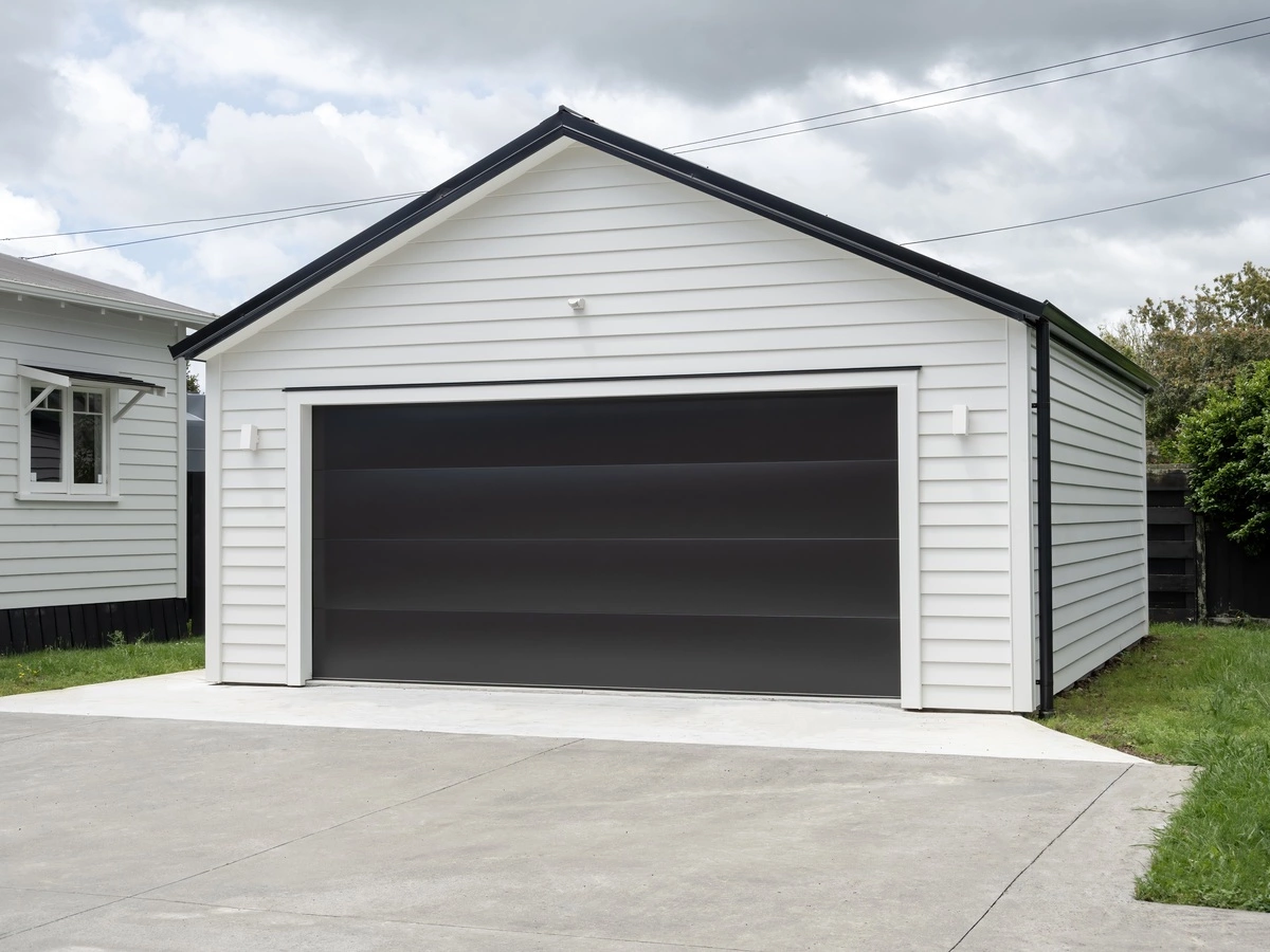 A stylish garage equipped with a black garage door, representing the expertise of local garage builders in Chicago.